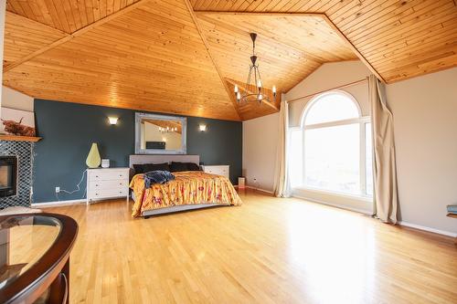 384 19 Road, Oliver, BC - Indoor Photo Showing Bedroom With Fireplace