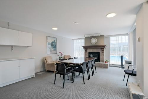 1103-1160 Sunset Drive, Kelowna, BC - Indoor Photo Showing Dining Room With Fireplace