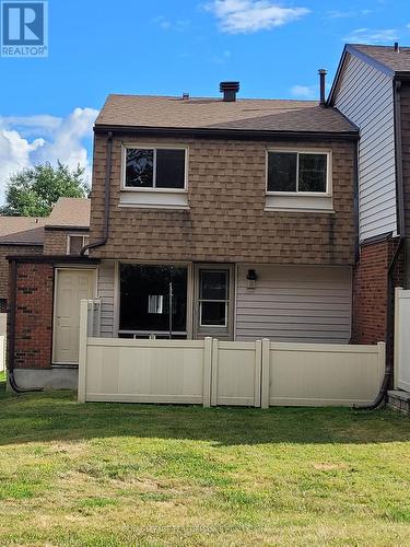 View of the rear of the home, fenced yard. - 903J Elmsmere Road, Ottawa, ON - Outdoor