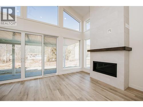 8200 97A Highway Unit# 8, Mara, BC - Indoor Photo Showing Other Room With Fireplace