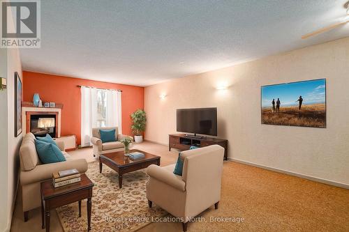 Virtually Staged Living Room - 1 - 891 River Road W, Wasaga Beach, ON - Indoor Photo Showing Living Room With Fireplace