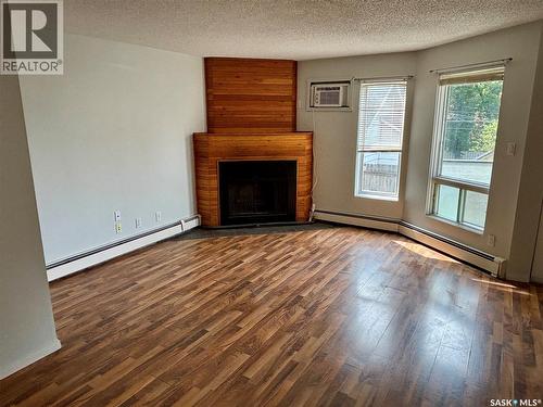 203 423 4Th Avenue N, Saskatoon, SK - Indoor Photo Showing Living Room With Fireplace