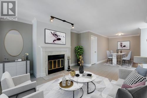 Photo Virtually Staged - 304 - 100 Bruyere Street, Ottawa, ON - Indoor Photo Showing Living Room With Fireplace