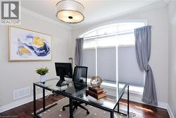 Office space featuring ornamental molding and dark wood-type flooring - 