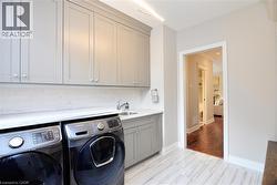 Laundry room featuring cabinet space and separate washer and dryer - 