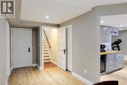 Bedroom with light wood-type flooring, recessed lighting, beverage cooler, and a dry bar - 