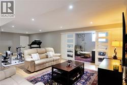 Living room featuring light wood finished floors and recessed lighting - 