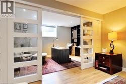 Bedroom with an office area and light wood-type flooring - 