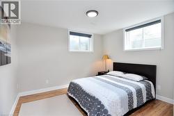 Bedroom featuring wood finished floors and baseboards - 