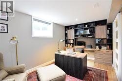 Home office with light wood-style floors and baseboards - 