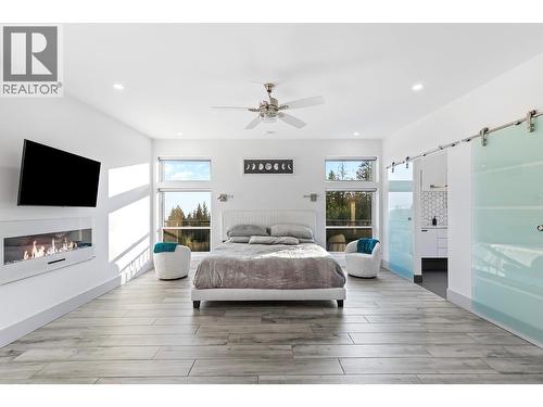 8195 Jackpine Road, Vernon, BC - Indoor Photo Showing Bedroom With Fireplace