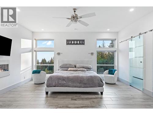 8195 Jackpine Road, Vernon, BC - Indoor Photo Showing Bedroom With Fireplace