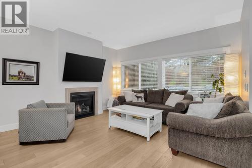 Cozy living room with ample natural lighting! - 1450 Union Road Unit# 41, Kelowna, BC - Indoor Photo Showing Living Room With Fireplace