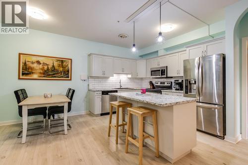 Space for bar seating - 151 Taylor Road Unit# 202, Kelowna, BC - Indoor Photo Showing Kitchen With Upgraded Kitchen
