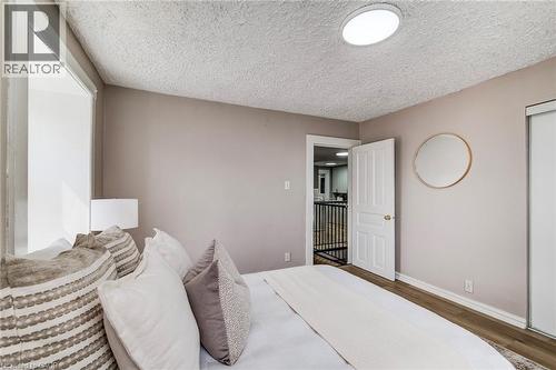 Bedroom featuring wood finished floors and a textured ceiling - 1331 King Street E, Cambridge, ON - Indoor Photo Showing Bedroom
