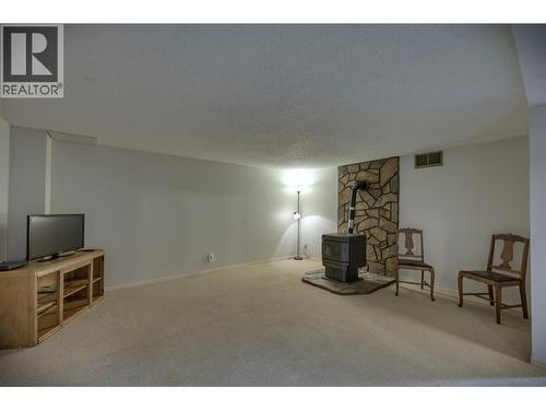 Large Family room with pellet stove on basement level - 7460 Valley Heights Drive, Grand Forks, BC - Indoor