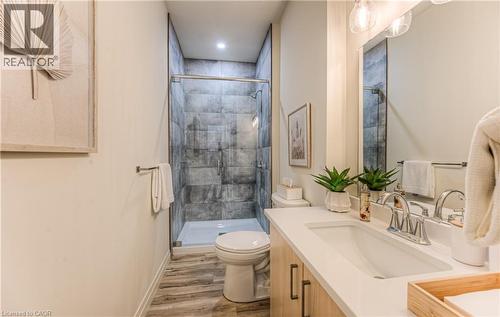 Full bath featuring vanity, light wood-style flooring, and a shower stall - 301 Westmount Road W Unit# 205, Kitchener, ON - Indoor Photo Showing Bathroom