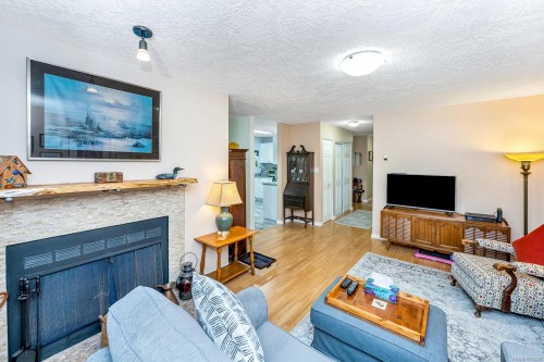 203-940 Inverness Rd, Saanich, BC - Indoor Photo Showing Living Room With Fireplace
