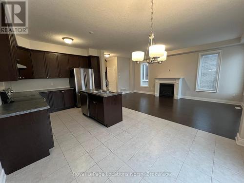 23 Lockerbie Crescent, Collingwood, ON - Indoor Photo Showing Kitchen With Fireplace With Double Sink