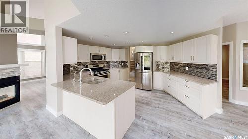 5006 Wascana Vista Court, Regina, SK - Indoor Photo Showing Kitchen With Fireplace With Stainless Steel Kitchen With Double Sink With Upgraded Kitchen