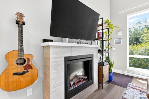 302-700 Yew Wood Rd, Tofino, BC - Indoor Photo Showing Living Room With Fireplace