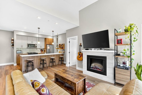 302-700 Yew Wood Rd, Tofino, BC - Indoor Photo Showing Living Room With Fireplace