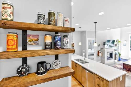 302-700 Yew Wood Rd, Tofino, BC - Indoor Photo Showing Kitchen With Fireplace With Double Sink