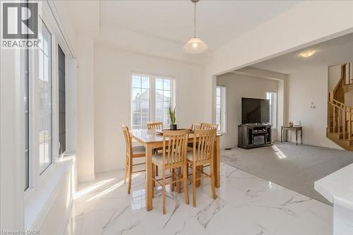 Dining area featuring stairs, plenty of natural light, and marble finish flooring - 35 Hitchman Street, Paris, ON - Indoor Photo Showing Dining Room