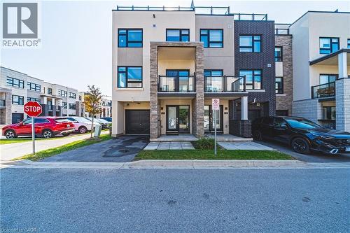 View of front of home featuring a balcony, stucco siding, asphalt driveway, and an attached garage - 1121 Cooke Boulevard Unit# 13, Burlington, ON - Outdoor With Balcony With Facade