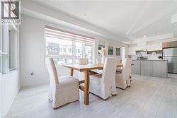 Dining space featuring light wood-type flooring and baseboards - 