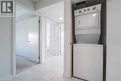 Laundry room featuring stacked washer / drying machine and baseboards - 