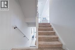 Stairway featuring baseboards and carpet flooring - 
