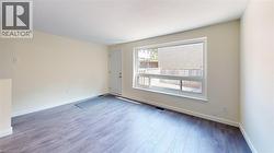 Unfurnished room with baseboards and light wood finished floors - 