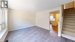 Spare room featuring stairway and wood finished floors - 