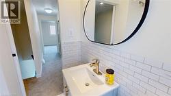 Half bath with tile walls, wainscoting, and vanity - 