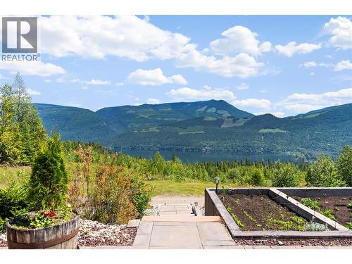 Pathway around the gardens - 1309 Eagle Ridge Road, Lumby, BC - Outdoor With Body Of Water With View