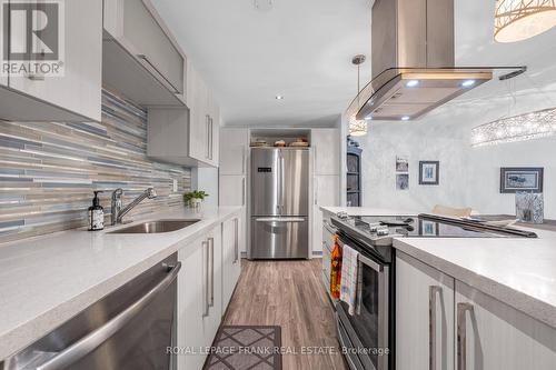SS APPLIANCES + LIGHTING & EXHAUST SYSTEM - 105 - 20 Speers Road, Oakville (Co Central), ON - Indoor Photo Showing Kitchen With Upgraded Kitchen