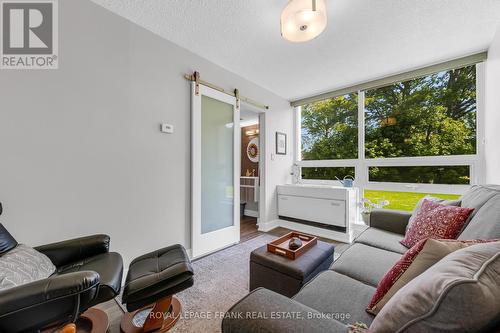 3RD BEDROOM/DEN WITH 2PC ENSUITE BATHROOM - 105 - 20 Speers Road, Oakville (Co Central), ON - Indoor Photo Showing Living Room
