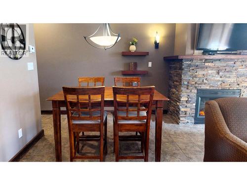 500 Bighorn Boulevard Unit# 513, Radium Hot Springs, BC - Indoor Photo Showing Dining Room With Fireplace