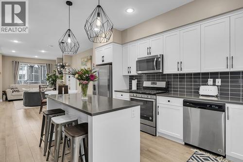 Bright spacious kitchen with gas stove - 2490 Tuscany Drive Unit# 24, West Kelowna, BC - Indoor Photo Showing Kitchen With Stainless Steel Kitchen
