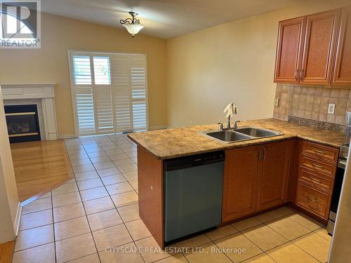 5077 Dubonet Drive, Mississauga, ON - Indoor Photo Showing Kitchen With Fireplace With Double Sink