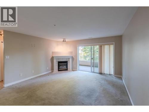 2245 Atkinson Street Unit# 205, Penticton, BC - Indoor Photo Showing Living Room With Fireplace