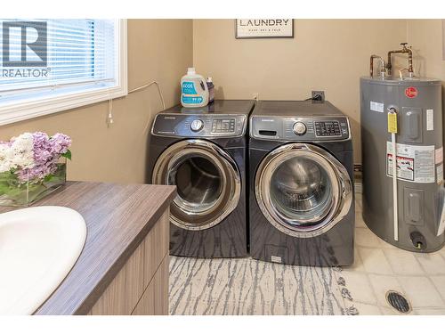 BATHROOM/LAUNDRY - Great Powder room and laundry right off the mudroom and close to kitchen! - 3404 Alexis Park Drive, Vernon, BC - Indoor Photo Showing Laundry Room