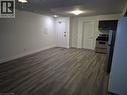 Unfurnished dining area featuring dark wood-style flooring - 27 Bridge Street Unit# 107, Brantford, ON  - Indoor 