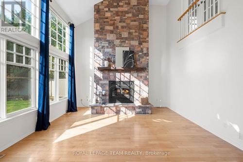 Dramatic floor-to-ceiling stone fireplace - 60 Ironside Court, Ottawa, ON - Indoor With Fireplace