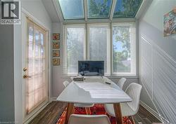Dining area featuring dark wood-style flooring and vaulted ceiling - 