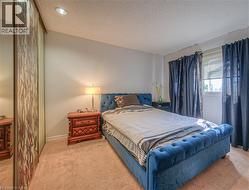 Bedroom featuring light carpet, a textured ceiling, and recessed lighting - 