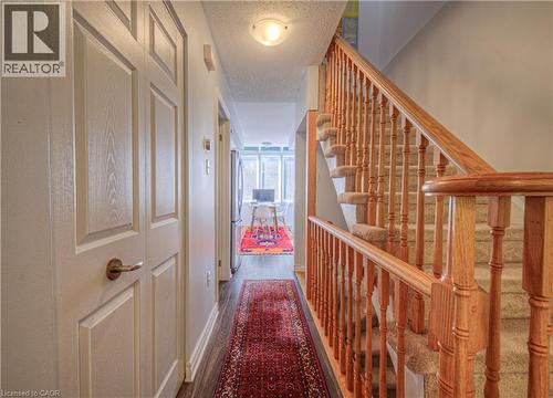 Hallway with a textured ceiling, wood finished floors, and stairs - 310 Christopher Drive Unit# 15, Cambridge, ON - Indoor Photo Showing Other Room