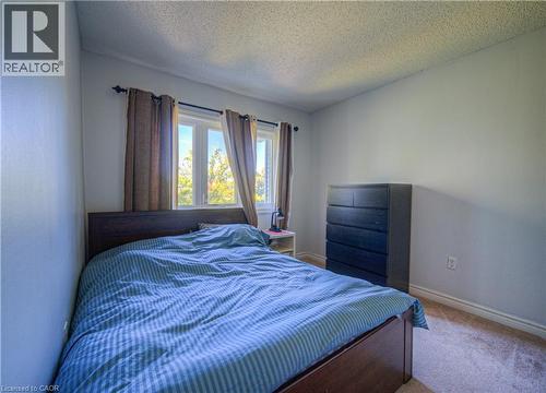 Bedroom with a textured ceiling and carpet floors - 310 Christopher Drive Unit# 15, Cambridge, ON - Indoor Photo Showing Bedroom