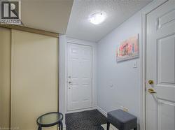 Entryway with a textured ceiling and tile patterned floors - 